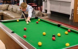 Sixth Form boy playing pool