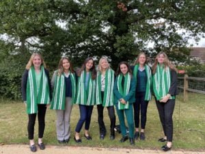 Team of House prefects with green house scarves