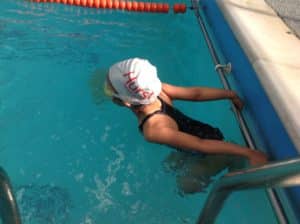 Girl in swimming pool ready to swim