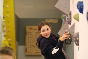 Hurst pupil on climbing wall