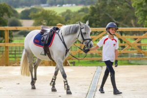 Young pupil leading a pony