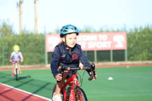 A girl cycling in the JPS Triathlon.